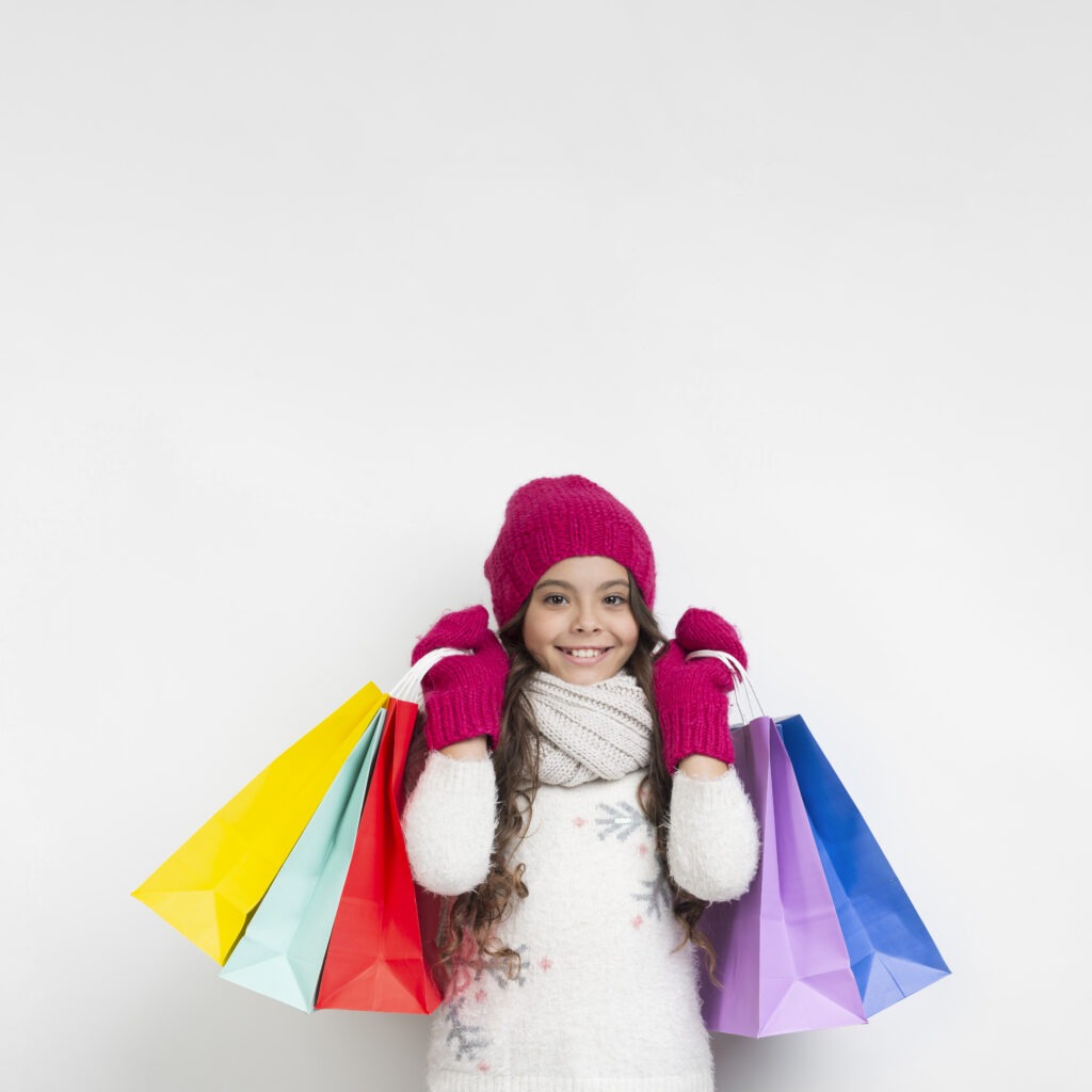 little-girl-holding-seasonal-shopping-bags